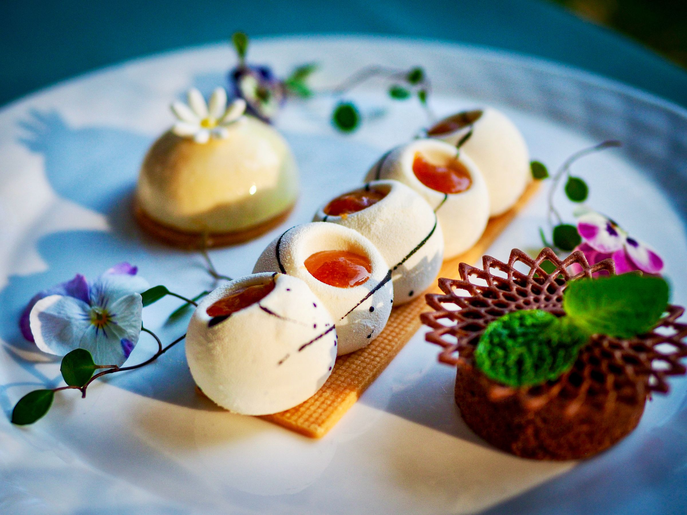 A dessert plated with pansies and meringue